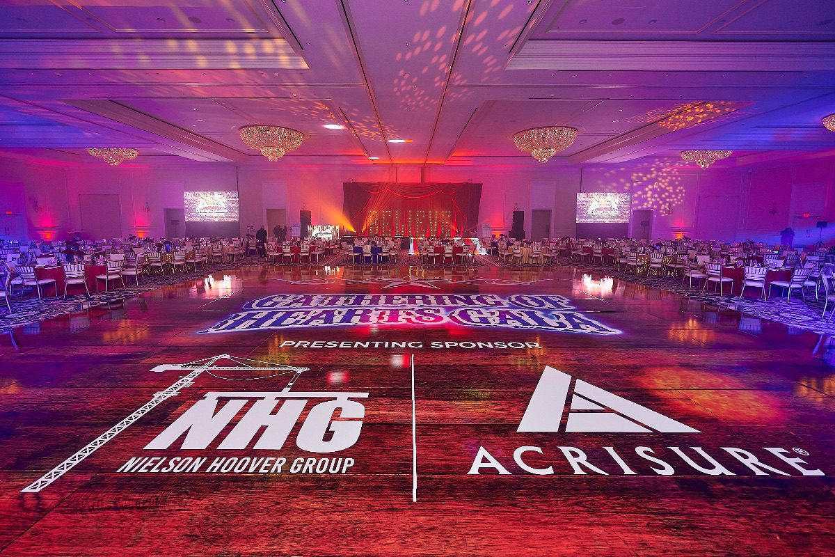 Gala dance floor with sponsor logos.