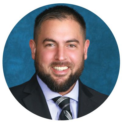 Smiling man in suit and tie.