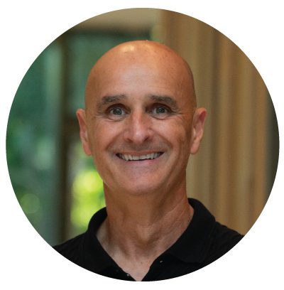 Smiling bald man in a black shirt.